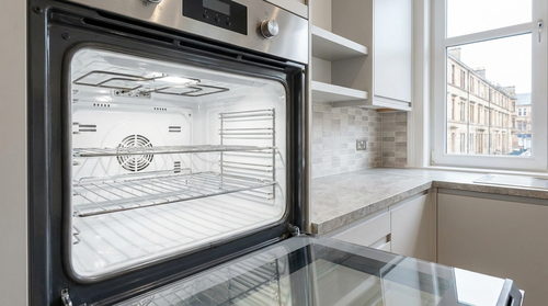 Gleaming professional oven after cleaning, modern Glasgow flat kitchen, bright stainless steel inter
